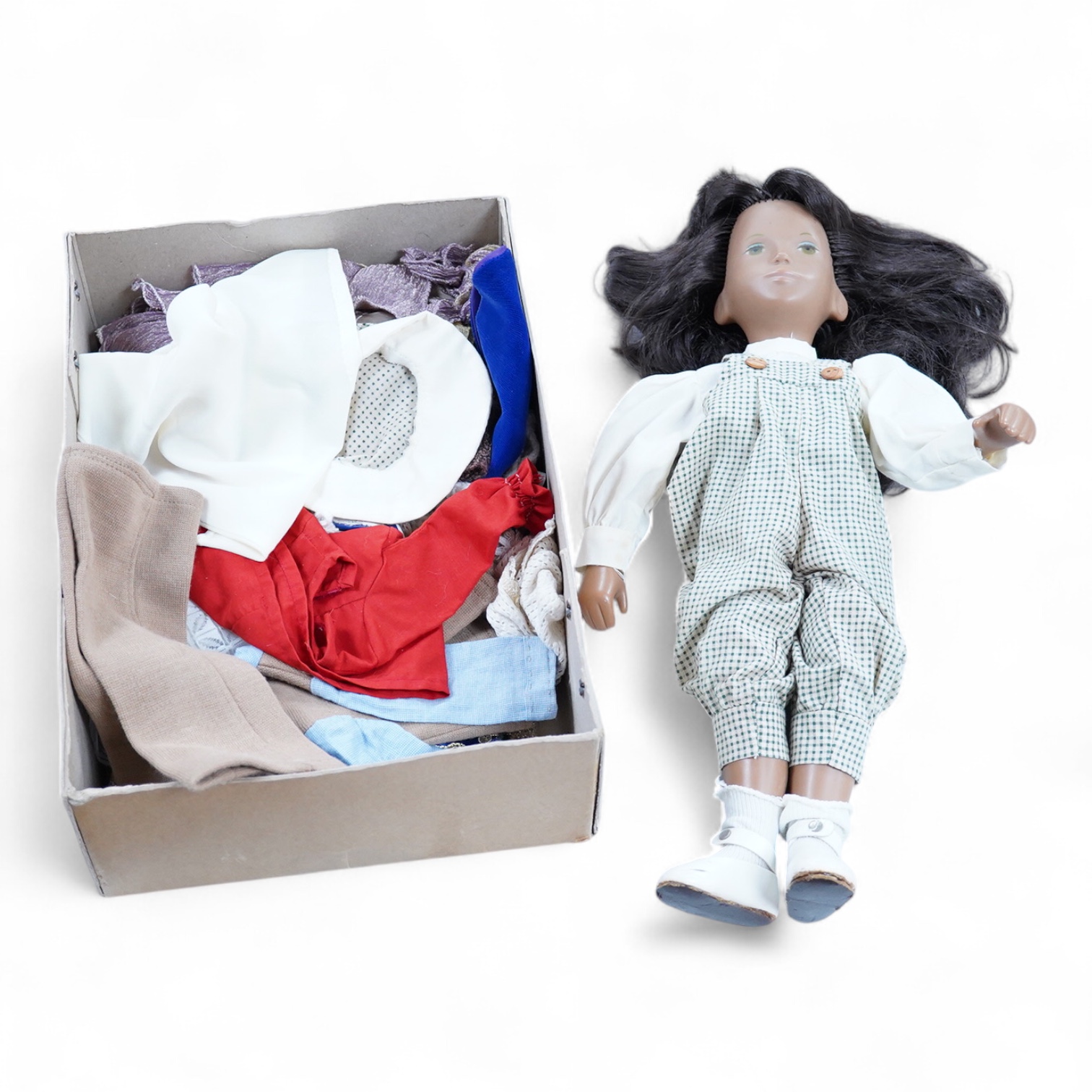 A Sasha Doll, 42cm high, with a selection of clothes, including some possible original commercially produced clothes together with other handmade clothes